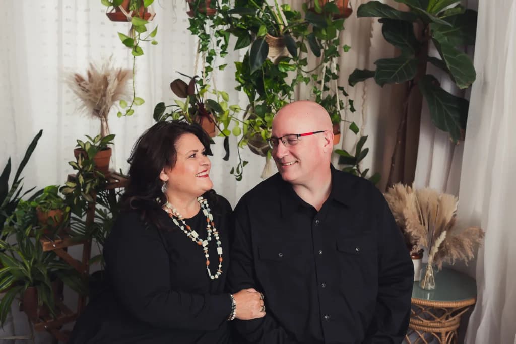 Chadwick Simpson, founder of RAD SEO, shares a warm moment with his wife Michele, surrounded by greenery in a cozy, inviting setting.